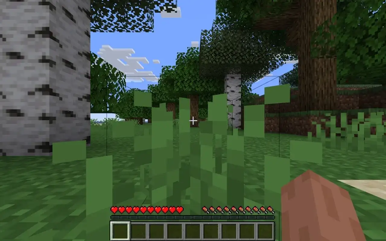 Gracz w świecie Minecraft zbiera trawę. Widać paski zdrowia i głodu.