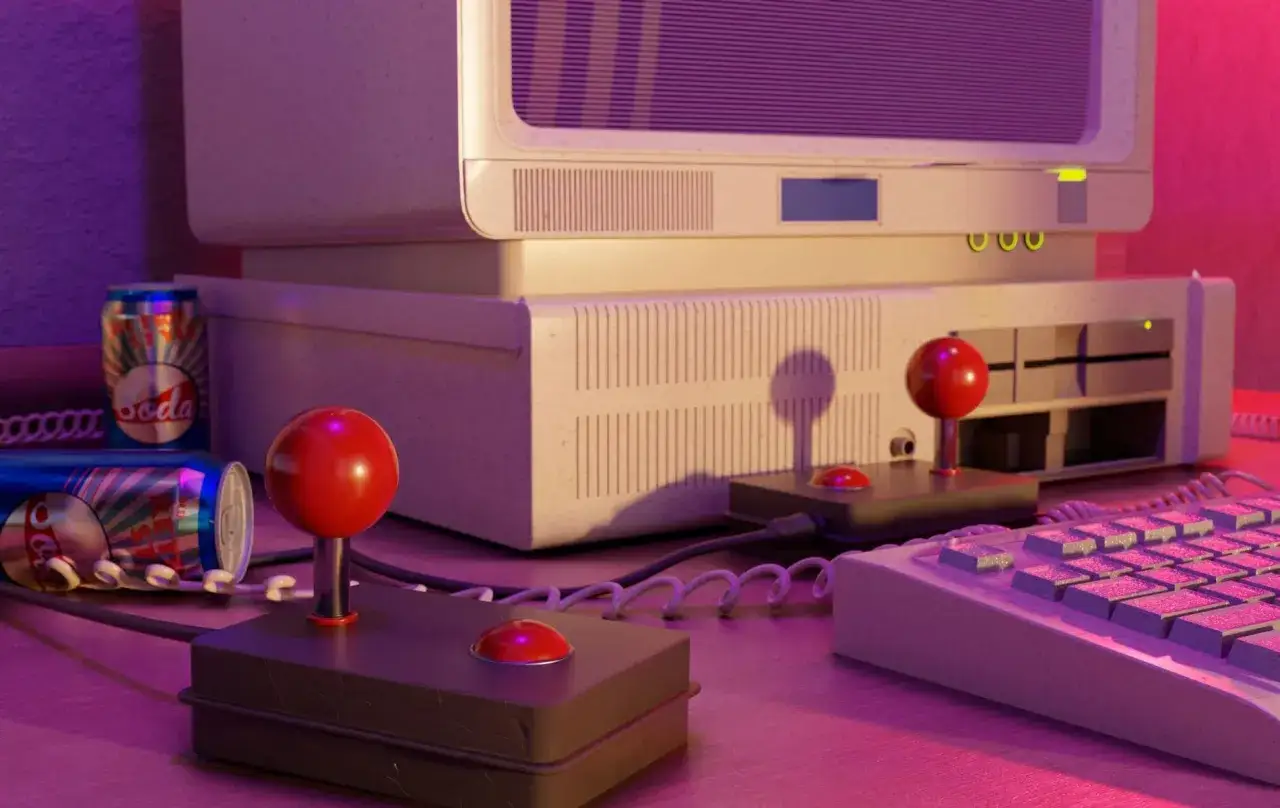 Nostalgiczne gry retro na starym komputerze z joystickami i puszkami napoju.